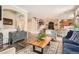 Stylish living room with hardwood floors, comfortable seating, and an open layout to the kitchen at 15496 W 66Th Dr # G, Arvada, CO 80007