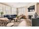 Inviting living room features plantation shutters, a cozy fireplace, and stylish decor at 15496 W 66Th Dr # G, Arvada, CO 80007