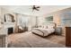 Spacious main bedroom with tray ceiling, fireplace, and cozy sitting area at 15496 W 66Th Dr # G, Arvada, CO 80007