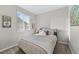 Bedroom featuring a queen bed with neutral bedding, and a light-filled window at 5270 Routt Ct # A, Arvada, CO 80002