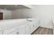 Modern white wet bar with quartz countertop at 8845 Yellowcress St, Littleton, CO 80125