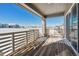 Spacious deck with wooden flooring and railings, offering scenic neighborhood views at 8845 Yellowcress St, Littleton, CO 80125