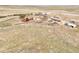 Idyllic aerial view shows the home, outbuildings and surrounding acreage, including mature trees and open fields at 1632 S County Road 137, Bennett, CO 80102