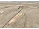 Wide aerial shot featuring a dirt road leading to ranch buildings in a vast rural landscape at 1632 S County Road 137, Bennett, CO 80102