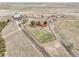 Aerial view of ranch land with a home, garage, and dirt roads at 1632 S County Road 137, Bennett, CO 80102