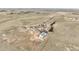 Wide shot of a ranch on a dirt lot with a home and multiple outbuildings at 1632 S County Road 137, Bennett, CO 80102