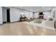 Finished basement with a brick fireplace, a neutral sofa, and stylish, light-toned wood-look flooring at 1632 S County Road 137, Bennett, CO 80102