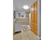 A tiled bathroom with a single sink vanity, medicine cabinet, and a glass shower with a shower curtain at 1632 S County Road 137, Bennett, CO 80102