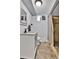 Bathroom featuring a single sink vanity and walk in shower, with natural light and neutral-toned walls and floors at 1632 S County Road 137, Bennett, CO 80102