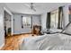 Bedroom with light gray walls, hardwood floors, and multiple windows allowing for ample natural light at 1632 S County Road 137, Bennett, CO 80102