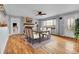 Bright dining room with hardwood floors, a brick fireplace, and large windows offering natural light at 1632 S County Road 137, Bennett, CO 80102