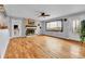 Dining area with hardwood floors, a cozy brick fireplace, and a large window offering views at 1632 S County Road 137, Bennett, CO 80102