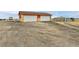 Garage exterior with two bays and a large gravel lot for convenient parking and storage at 1632 S County Road 137, Bennett, CO 80102