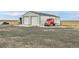 Large outbuilding with two garage doors and space for equipment and vehicle parking at 1632 S County Road 137, Bennett, CO 80102