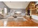 Inviting living room with stone fireplace, tiled floors, and large windows offering scenic views at 1632 S County Road 137, Bennett, CO 80102