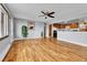 Open living area with hardwood floors seamlessly connecting to the kitchen, ideal for entertaining at 1632 S County Road 137, Bennett, CO 80102