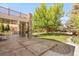 Expansive backyard featuring a covered patio with stone pillars and a lush lawn with mature trees at 13971 Star Creek Dr, Broomfield, CO 80023