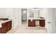 A bathroom with dark wood cabinets, double sinks, marble floors, and ample space, perfect for a primary bathroom at 13971 Star Creek Dr, Broomfield, CO 80023