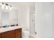 A well lit bathroom featuring a shower, toilet, and vanity with stylish backsplash at 13971 Star Creek Dr, Broomfield, CO 80023