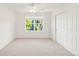 A bright bedroom with white walls, a window, sliding closet doors, and carpet floors offer a clean and cozy room at 13971 Star Creek Dr, Broomfield, CO 80023