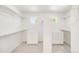 A walk-in closet with carpet floors, some shelves and a bright white interior provides ample space for storage at 13971 Star Creek Dr, Broomfield, CO 80023