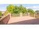 Large deck with wood flooring, stone pillar supports, and wood railings overlooking the backyard at 13971 Star Creek Dr, Broomfield, CO 80023