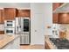 A kitchen featuring wood cabinets, stainless steel appliances, and granite countertops, providing a luxurious cooking space at 13971 Star Creek Dr, Broomfield, CO 80023