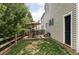 Backyard patio with outdoor dining set, seating, an umbrella, and a well-maintained lawn at 4619 S Tabor Way, Morrison, CO 80465
