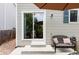 Back patio featuring a cushioned chair and table, along with the sliding back door at 4619 S Tabor Way, Morrison, CO 80465