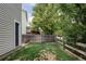 Backyard featuring well-maintained grass and a wooden fence, offering privacy and a green space at 4619 S Tabor Way, Morrison, CO 80465