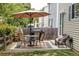 Backyard patio with outdoor dining set, seating, grill, and a manicured lawn at 4619 S Tabor Way, Morrison, CO 80465
