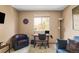 Brightly lit bedroom featuring a work desk, a sofa, a decorative wall hanging and a window at 4619 S Tabor Way, Morrison, CO 80465