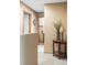 Hallway area with neutral paint and carpets, decorated with a vase and lamp on a table at 4619 S Tabor Way, Morrison, CO 80465