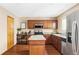 Well-lit kitchen featuring wood cabinets, granite countertops, stainless steel appliances, and a center island at 4619 S Tabor Way, Morrison, CO 80465
