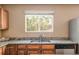 Kitchen counter features granite countertops, stainless steel sink, and a window with natural light at 4619 S Tabor Way, Morrison, CO 80465