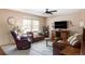 Inviting living room featuring leather seating, ample natural light, and a modern ceiling fan at 4619 S Tabor Way, Morrison, CO 80465