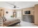 Spacious main bedroom featuring a ceiling fan, a queen bed, and a large dresser with a wall-mounted TV at 4619 S Tabor Way, Morrison, CO 80465