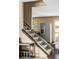 View of carpeted staircase with wooden trim, stainless steel refrigerator, and hardwood floors at 4619 S Tabor Way, Morrison, CO 80465