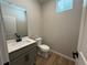 Powder room featuring modern vanity with light countertops, new fixtures, and tile floors at 18348 E 93Rd Pl, Commerce City, CO 80022