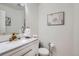 Stylish half bathroom featuring elegant fixtures and a modern vanity with attractive wall art at 1179 S Fultondale Cir, Aurora, CO 80018
