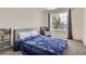 Comfortable bedroom with a large window, cozy carpeting, and a stylish reading chair at 1179 S Fultondale Cir, Aurora, CO 80018