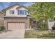 Charming two-story home with stone accents, a well-manicured lawn, and attractive exterior finishes at 1179 S Fultondale Cir, Aurora, CO 80018