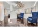 Bright, open living space with hardwood floors, a fireplace, and a stunning chandelier at 1179 S Fultondale Cir, Aurora, CO 80018