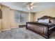 Spacious main bedroom with a decorative ceiling fan, large window and luxurious bed at 1179 S Fultondale Cir, Aurora, CO 80018