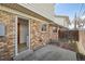 Patio and backyard area featuring a brick wall, door to interior, and privacy fence at 4655 Independence St # 3, Wheat Ridge, CO 80033