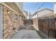 Small outdoor area featuring a wood fence, red rock mulch, and a concrete patio at 4655 Independence St # 3, Wheat Ridge, CO 80033