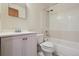 Bathroom featuring a white vanity, toilet, and a bathtub with white tile surround at 4655 Independence St # 3, Wheat Ridge, CO 80033