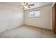 A bright bedroom with a ceiling fan, carpeted floors, and a window at 4655 Independence St # 3, Wheat Ridge, CO 80033