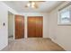 Bedroom featuring carpeted floors, a closet, and a ceiling fan at 4655 Independence St # 3, Wheat Ridge, CO 80033