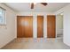 A bedroom with carpet, closet doors, and a view to a stairwell at 4655 Independence St # 3, Wheat Ridge, CO 80033